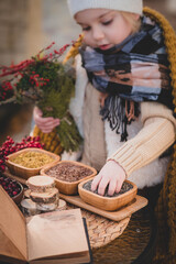 Child reading recipe book to prepare to halloween