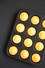 Homemade Cornbread Muffins on a black background, top view. Flat lay, overhead, from above. Copy space.