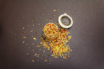 Fototapeta premium Mix of variety of cereals in glass jar on black stone background