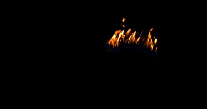 A spot of real flames starts to burn on a black background. Isolated Igniting fire. 50 fps, Apple ProRes 422. Perfect for compositing layer with different blending modes