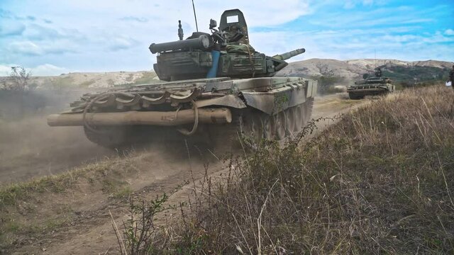 Military tank rides on the road
