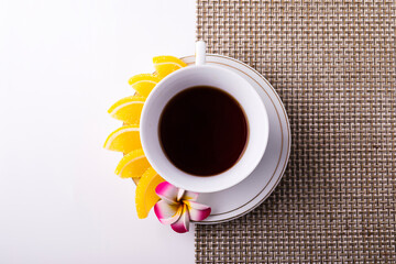 Obraz na płótnie Canvas White tea Cup with lemon slices on a saucer, marmalade.
