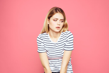 Obraz premium Woman in striped t-shirt emotions studio cropped view lifestyle pink isolated background
