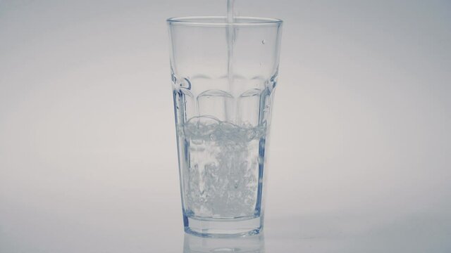 filling glass of water on white background, healthy lifestyle, drink water, pure fresh water