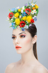 Profile beauty portrait. Beautiful girl with spring colorful flowers. Beauty Face. Creative Make up and Hair Style.