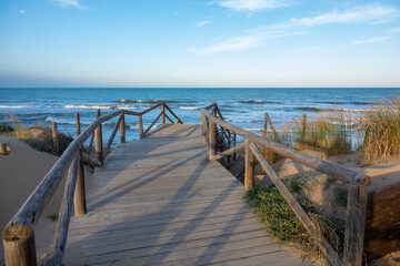 Broadwalk to a sand beach at  Mediterranean ocean in Spain