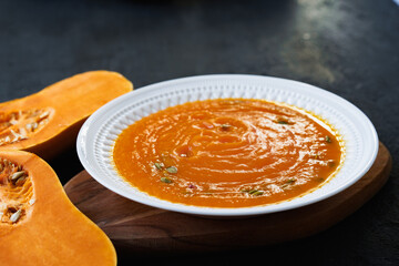 Homemade pumpkin soup on a black table