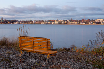 Empty bench by the river