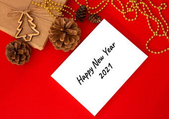 mock up poster on red table surrounded by pine cones and new year christmas atrebutics