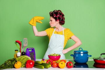 Portrait of her she nice attractive mature glamorous funky crazy housewife cooking domestic meal talking with glove hand fooling grimacing isolated over green pastel color background