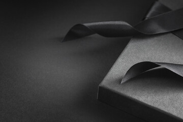 Gift box with bow closeup. Black color.