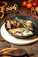 Mutton ribs with vegetables rice in cast iron pan