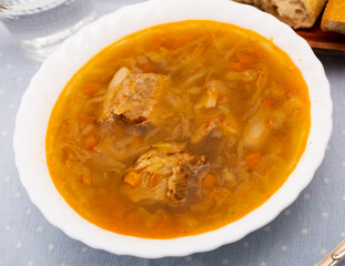 Appetizing Russian dish Shchi sour cabbage soup served in bowl