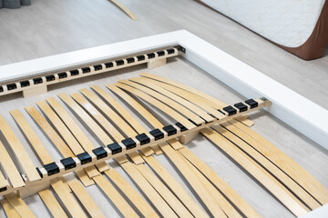 Broken wooden plank or lamella in bed. Need for furniture repair.