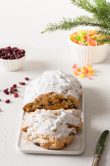 Christmas stollen - traditional German bread on white background. Close up. Vertical format.