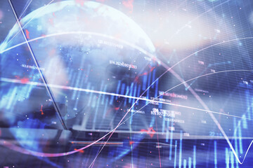 Stock market graph on background with desk and personal computer. Multi exposure. Concept of financial analysis.