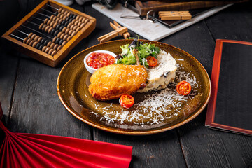 Dish of chicken fillet Kiev cutlet with rice