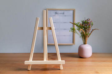 wooden easel on empty interior background