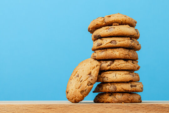Stack of chocolate chip cookies against blue background