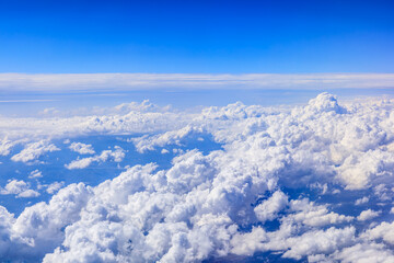 Fototapeta na wymiar Clouds and sky as seen through window of an aircraft.