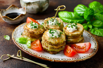 Fried zucchini with sauce, dill, parsley and garlic.