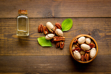 Layout of pecan nuts oil. Vegan food background, top view