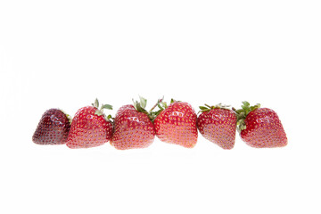 red raw fresh strawberries on white background, close view 