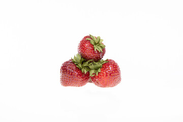 red raw fresh strawberries on white background, close view 