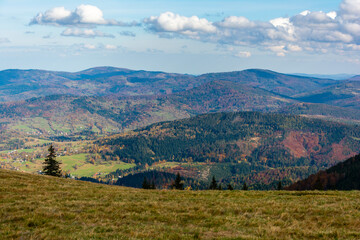 Autumn landscape of mountain hills covered with colorful forests. Zywiec Beskids.