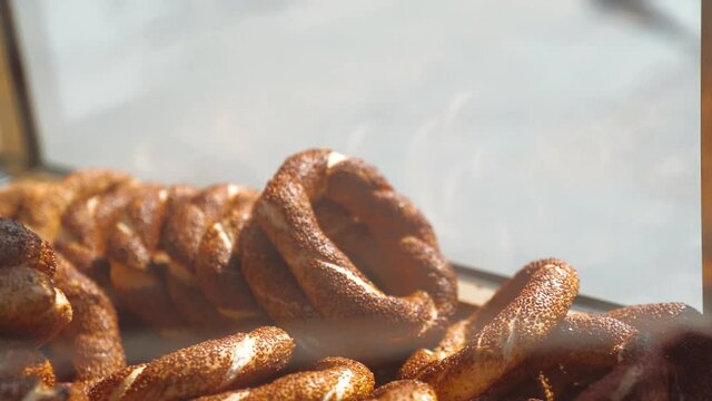 Hand of a man picking a turkish bagel simit