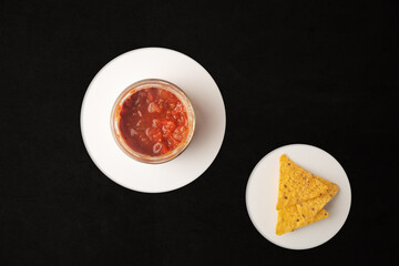 nachos with red tomato and chilli sauce