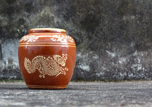 Handicraft, glazed pottery jar with ancient dragon pattern from Thailand Ratchaburi, made from clay, used for decoration or general storage jar.