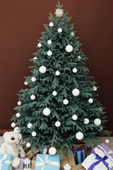 Christmas tree pine with gifts decor brown background 2021 2022