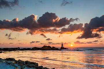 Scenery amazing sunrise at Ahtopol lighthouse, Black Sea, Southeastern Bulgaria. Beautiful clouds and vivid colors in the picture, copy space available. October travel photo.