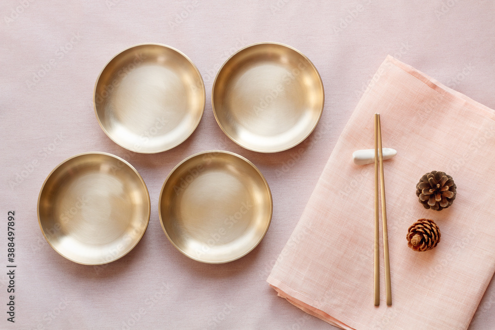 Wall mural korean high quality brass tableware with chopsticks. top view.