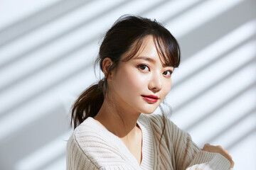 光と影の背景の若い女性のビューティーポートレート