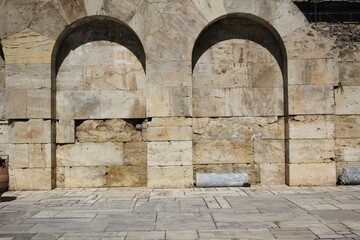 Arched wall of ancient stones in Athens, Greece.