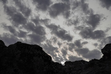 Rain clouds accumulating in the sunset sky.