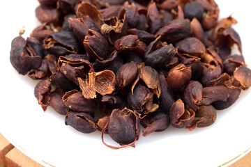  Cascara or dried coffee cherry pulp and outer skin in white plate for background or texture. Cascara can make the tea beverage.