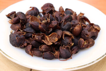  Cascara or dried coffee cherry pulp and outer skin in white plate for background or texture. Cascara can make the tea beverage.