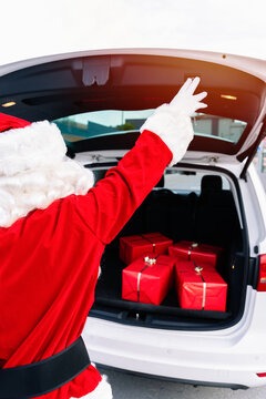 Portrait Of Santa Claus Closing The Trunk Of The Open Car Full Of Gifts For Delivery In The Christmas Of 2020