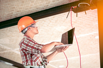 The technician is checking the signal. After installing the Internet in the building