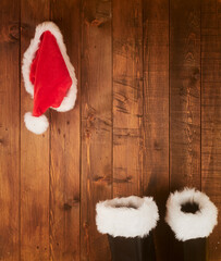 Santa Claus boots and hat  hanging on Wood wall