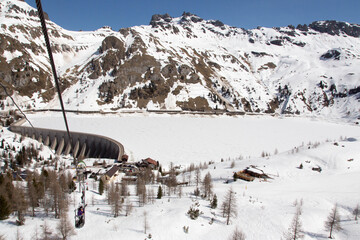 fedaia dam with frozen lake, Italian alps