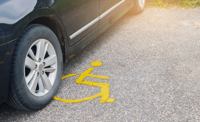 Car parking on handicap parking sign symbol at asphalt parking lot, special car parking area for...