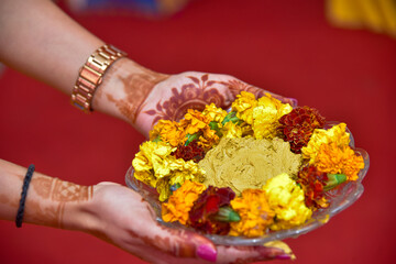 Traditional Haldi turmeric kept on a flower plate for the hindu marriage ceremony.