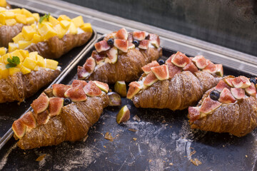 croissants, cream and fresh fruit on a tray.