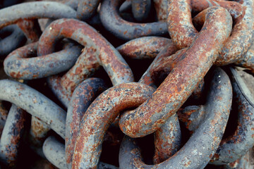 rusty tangled chains in a ball with thick links - closeup steampunk texture for a heavy wallpaper