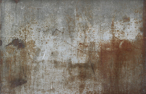 rusty metal surface with gray and light brown tones - worn steampunk background with scratches and grooves