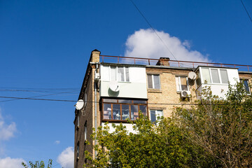 old balcony of old house and birch grow on the balcony